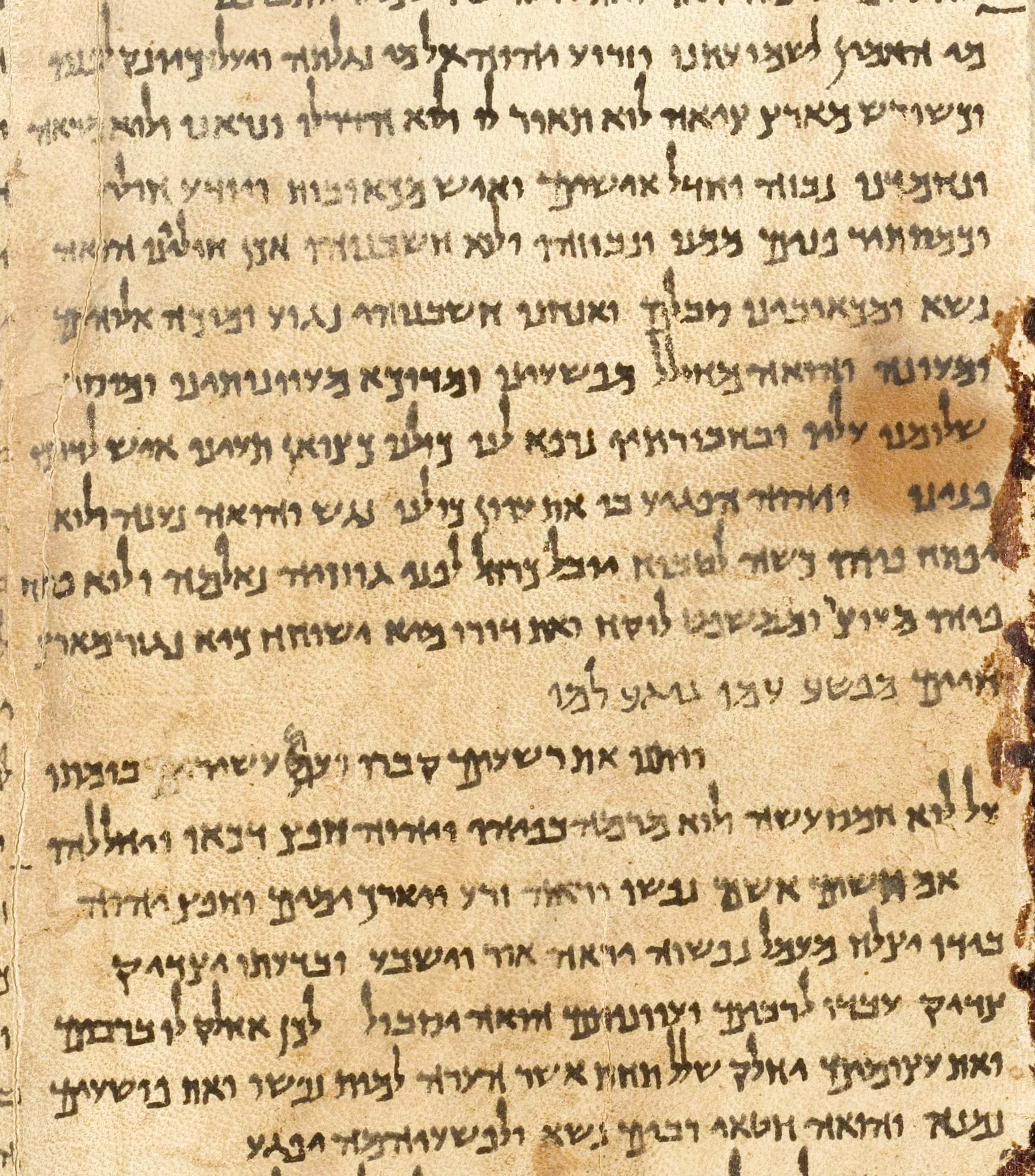 A column of the Great Isaiah Scroll (1QIsa-a) from Qumran, showing Hebrew text of Isaiah 53 written in carbon-based ink on parchment around 125 BCE.
