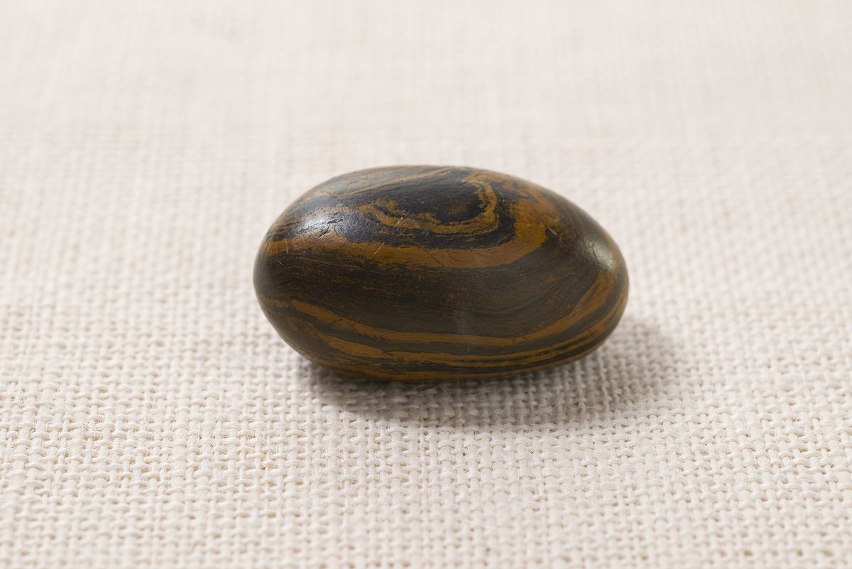 Chocolate-colored oval seer stone photographed against a neutral background; the stone is roughly the size of a hen's egg, smooth, with a polished surface. Official Church photograph first published in October 2015.