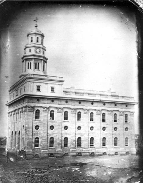 Daguerreotype of the original Nauvoo Temple completed in 1846 — a four-story Greek Revival structure with a single steeple, sun-stones, moon-stones, and star-stones carved into its pilasters, photographed before its destruction.
