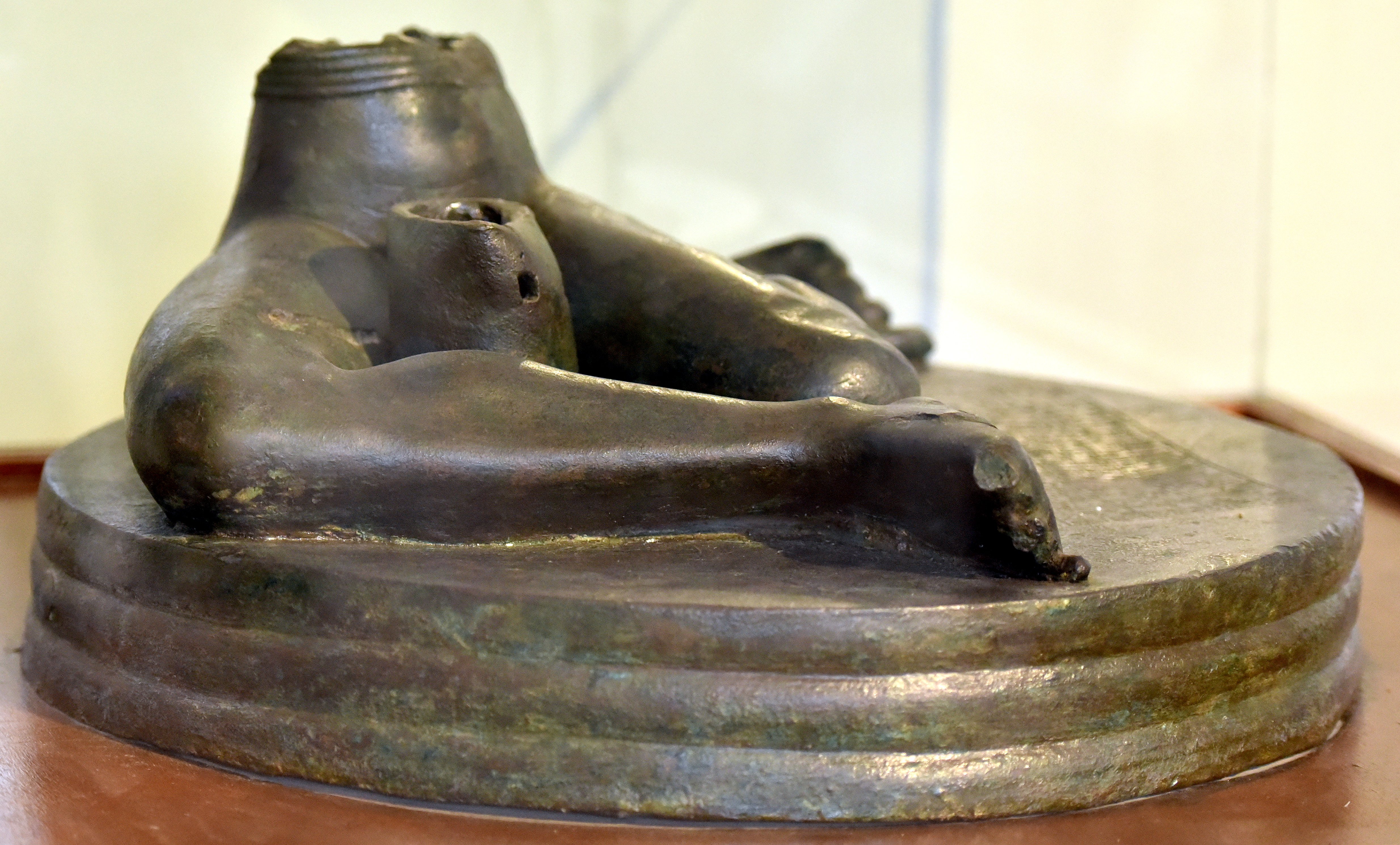 The Bassetki Statue, a copper-alloy Akkadian-period royal statue base inscribed with the cuneiform inscription of Naram-Sin of Akkad (~23rd century BC) recording his campaign as far as Ulisum — the proposed match for the Book of Abraham's Olishem. Iraq Museum, Baghdad.