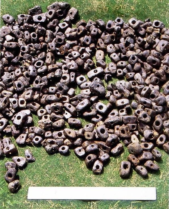 Photograph of polished and perforated ilmenite iron-ore beads, dated to ~1100 BC, excavated by Ann Cyphers Guillén at the Olmec workshop at San Lorenzo, Veracruz, Mexico