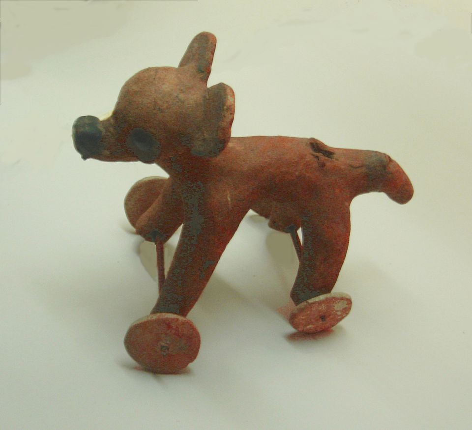 Pre-Columbian Mesoamerican wheeled clay dog figurine from the Remojadas culture (Veracruz, Mexico), dated approximately AD 1–900, showing axles and wheels on all four legs